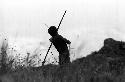 Samuel Putnam negatives, New Guinea; a young warrior shoots an arrow