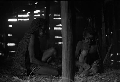 Samuel Putnam negatives, New Guinea; 2 women in a hunu