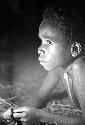 Samuel Putnam negatives, New Guinea; small boy lying in honai; face and shoulders and head