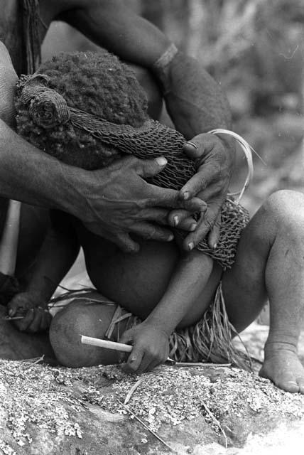 Samuel Putnam negatives, New Guinea; woman and little child; she holds it with her hands