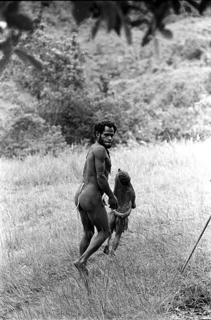 Samuel Putnam negatives, New Guinea; man and child walking near the Anelerak