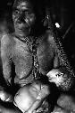 Samuel Putnam negatives, New Guinea; Aneake with small child in her lap in Wuperainma hunu; Aneake's face