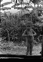 Samuel Putnam negatives, New Guinea; child looks into the honai