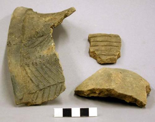 Ceramic rim and body sherds, incised and punctate design, some repaired