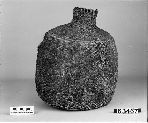 Pitch-covered wicker bottle. From the collection of L.H. Farlow. Said to have been taken from a cave in California.