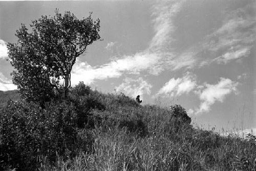 Samuel Putnam negatives, New Guinea; a man sits on the Anelerak