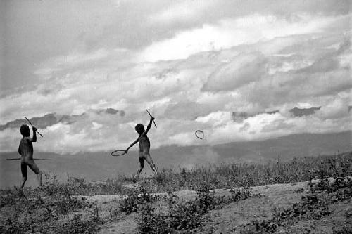 Samuel Putnam negatives, New Guinea; boy throws a spear; hoop in the air