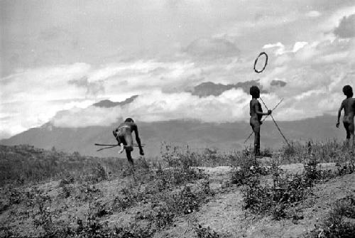 Samuel Putnam negatives, New Guinea; hoop bounding near boys playing sikoko wasin