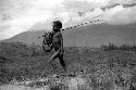 Samuel Putnam negatives, New Guinea; young boy with many hoops in his spear; he is going home