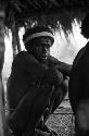 Samuel Putnam negatives, New Guinea; man squats under an olea