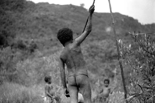 Samuel Putnam negatives, New Guinea; Tukom raises his spear to throw it into a hoop