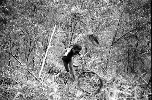 Samuel Putnam negatives, New Guinea; Tukom has thrown a spear at a hoop that rolled past him