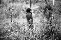Samuel Putnam negatives, New Guinea; Tukom; hands clasped on his shoulders stands in the pavi grove