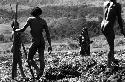 Samuel Putnam negatives, New Guinea; 2 or 3 men talking to a woman who has come by near a field