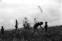 Samuel Putnam negatives, New Guinea; little boy has just thrown a hoop