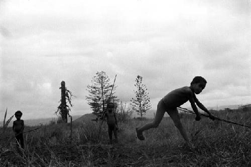 Samuel Putnam negatives, New Guinea;little boy has just thrown a hoop