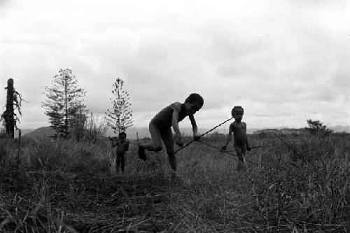 Samuel Putnam negatives, New Guinea;little boy has just thrown a hoop