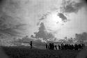 Samuel Putnam negatives, New Guinea; silhouetted men and women dancing late at an Etai