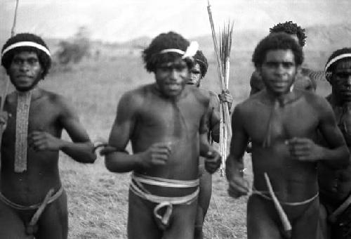 Samuel Putnam negatives, New Guinea;  four men dance towards the camera