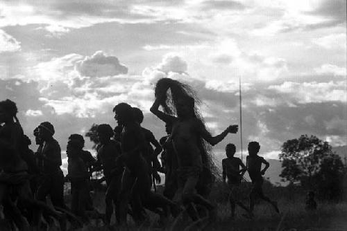 Samuel Putnam negatives, New Guinea; a group of women and men running