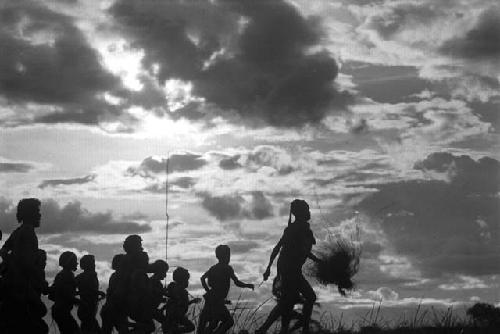 Samuel Putnam negatives, New Guinea; a group of women and men running