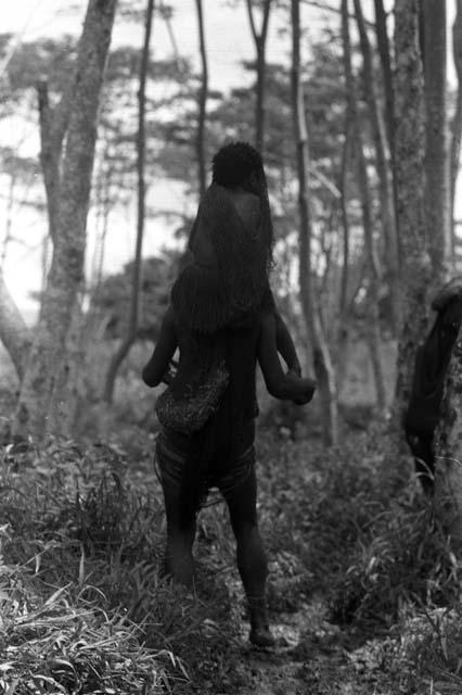 Samuel Putnam negatives, New Guinea; woman carrying a baby