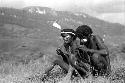 Samuel Putnam negatives, New Guinea; Walimo and another man sitting and talking