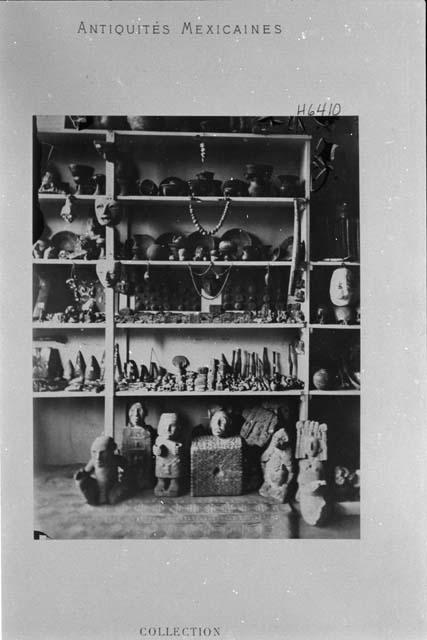 Collection of various artifacts - all types, all materials. Caption reads: "Collection Eugéne Boban Duvergé, Paris." Commercialized (?) studio photo of someone's shop/collection of Mexican artifacts, in Paris. A collection of 2,025 objects.