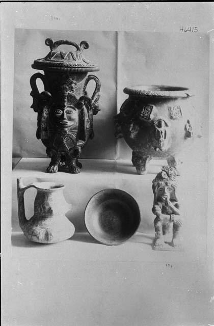 Various ceramic vessels, including an effigy pot with a human face and a human figure. Probably Peabody Museum vessels.