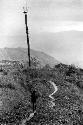 Samuel Putnam negatives, New Guinea; a woman walks back from Hellerabet