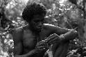 Samuel Putnam negatives, New Guinea; a man knitting a nyeraken are; man with one eye