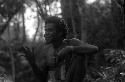 Samuel Putnam negatives, New Guinea; a man knitting a nyeraken are; man with one eye