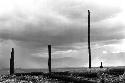 Samuel Putnam negatives, New Guinea; a boy against the skyline up with the partially finished structure where they gather wood