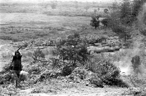 Samuel Putnam negatives, New Guinea; a woman walking up towards Lokoparek from Abukulmo