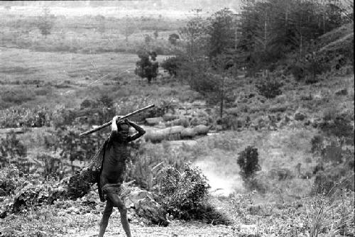 Samuel Putnam negatives, New Guinea; a woman walking up towards Lokoparek from Abukulmo