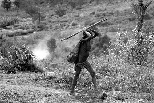 Samuel Putnam negatives, New Guinea; a woman walking up towards Lokoparek from Abukulmo