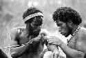 Samuel Putnam negatives, New Guinea; Mu working on Aloro's tekan