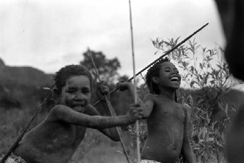 Samuel Putnam negatives, New Guinea; little girls palying sikoko wasin; one is laughing uproariously