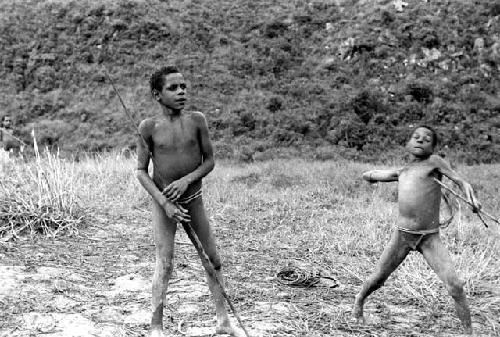 Samuel Putnam negatives, New Guinea; Isile and another boy; playing sikoko wasin