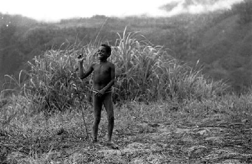 Samuel Putnam negatives, New Guinea; boys playing sikoko wasin; hoop rolling past; spears