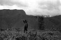 Samuel Putnam negatives, New Guinea; boys playing sikoko wasin; hoop rolling past; spears