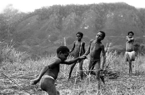 Samuel Putnam negatives, New Guinea; boys playing sikoko wasin; Isile and Okal