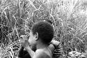 Samuel Putnam negatives, New Guinea; one boy in a mob of boys wrestling