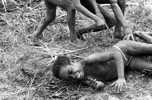 Samuel Putnam negatives, New Guinea; boys rolling on the ground