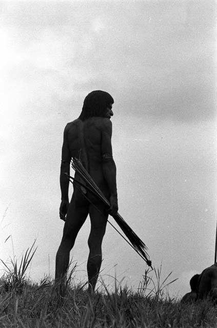 Samuel Putnam negatives, New Guinea; Nilik standing on the end of the Warabara watching the battle