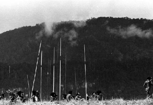 Samuel Putnam negatives, New Guinea; men and spears outlined against the dark eastern hills