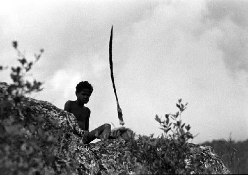 Samuel Putnam negatives, New Guinea; a boy on the Warabara; there is an inamossi in fromt of him; he looks at the camera