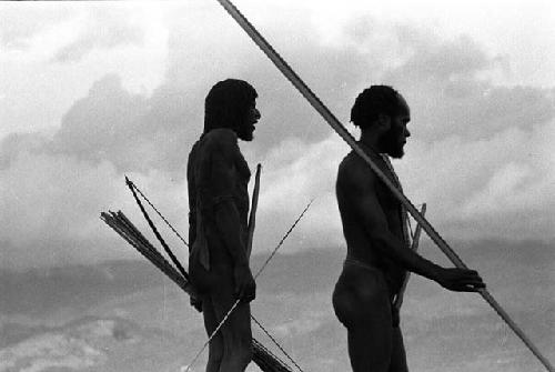 Samuel Putnam negatives, New Guinea; Nilik and another man watching the battle which has been engaged again