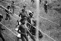 Samuel Putnam negatives, New Guinea; men running out along the lee of the Warabara to join battle