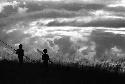 Samuel Putnam negatives, New Guinea; 2 men; late in the evening of the battle between the WW and Wittaia out on the end of the Warabara; they are silhouettes against the the sky
